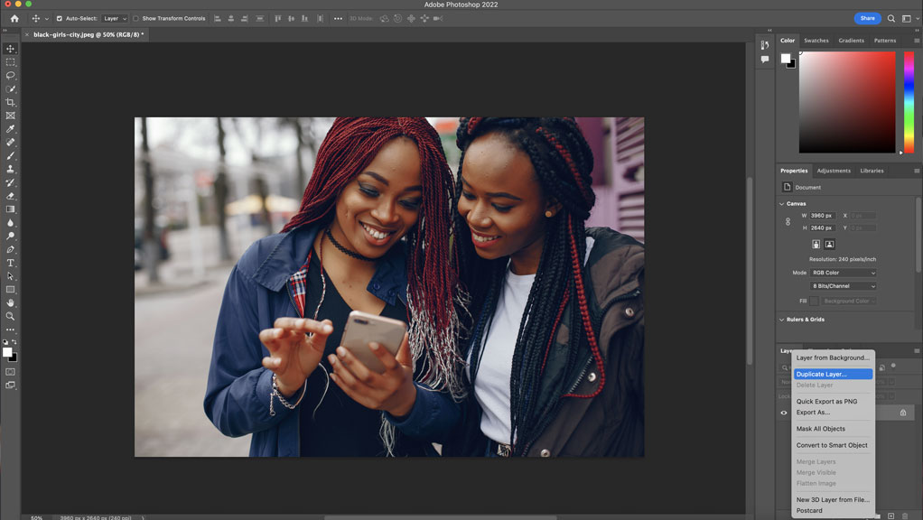 Screenshot of the Photoshop artboard with an image of two ladies looking into a phone