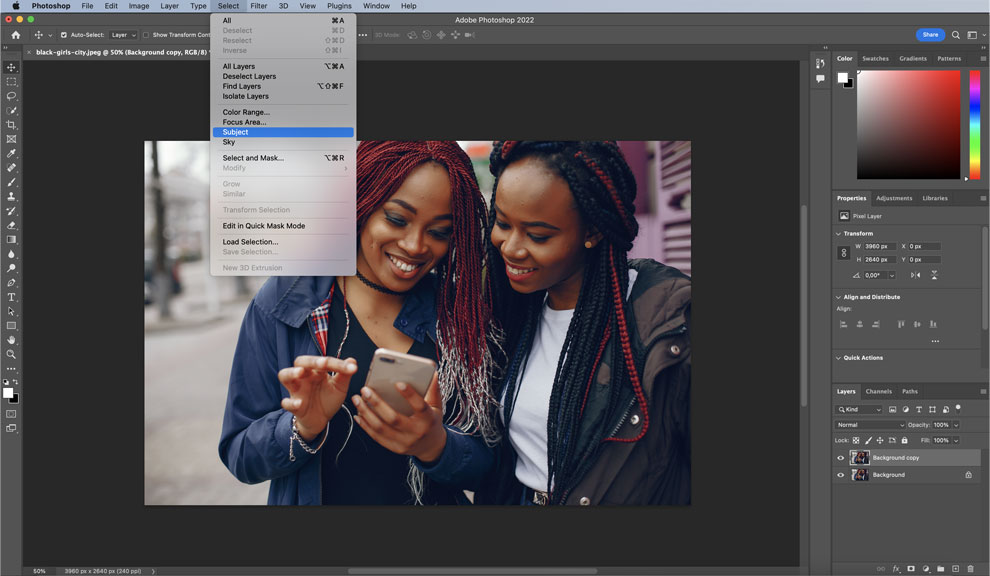 Screenshot of the Photoshop artboard with an image of two ladies looking into a phone.
