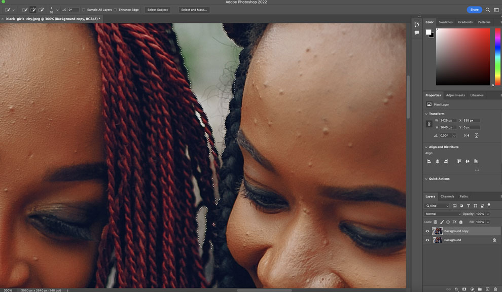 Screenshot of the Photoshop artboard with an image of two ladies looking into a phone.